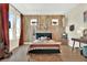 Eclectic bedroom with bohemian decor, stylish accent wall, wood floors and natural light from two windows at 6542 Rover Way, St Cloud, FL 34771