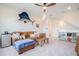 Spacious bonus room with ceiling fan, leather couch, playful decor, and ample natural light at 6542 Rover Way, St Cloud, FL 34771