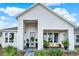 Charming home featuring a covered porch, light blue door, beautifully landscaped front yard and striking architectural details at 6542 Rover Way, St Cloud, FL 34771