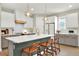 Bright kitchen features a large island, pendant lighting, modern appliances and ample cabinet storage at 6542 Rover Way, St Cloud, FL 34771
