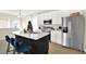Modern kitchen featuring stainless steel appliances, a large island with seating, and ample counter space at 6542 Rover Way, St Cloud, FL 34771