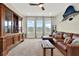 Spacious living room featuring a large entertainment center, leather couch, neutral walls, and plush carpet at 6542 Rover Way, St Cloud, FL 34771