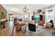 Open-concept living room featuring modern decor, a view of the kitchen, and plenty of natural light at 6542 Rover Way, St Cloud, FL 34771