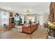 Bright living room with an open floor plan, wooden floors, stylish lighting, and inviting seating arrangements at 6542 Rover Way, St Cloud, FL 34771