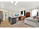 Open concept living space featuring kitchen island, cozy seating area, and bedroom with natural light at 6542 Rover Way, St Cloud, FL 34771