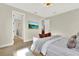 Bright main bedroom with hardwood flooring, sitting area and doorway to the bathroom with glass enclosed shower at 6542 Rover Way, St Cloud, FL 34771