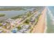 Aerial view showcasing the property's ideal location near the beach and river at 6771 Turtlemound Rd, New Smyrna Beach, FL 32169