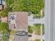 Beautifully landscaped property with a rooftop deck, spacious parking, and palm trees enhancing curb appeal at 6771 Turtlemound Rd, New Smyrna Beach, FL 32169