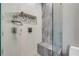 This shower stall features grey marble wall, built in bench, storage, and modern fixtures at 6771 Turtlemound Rd, New Smyrna Beach, FL 32169