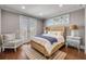 Bright bedroom featuring hardwood floors, French doors, and a comfortable seating area at 6771 Turtlemound Rd, New Smyrna Beach, FL 32169