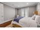 Comfortable bedroom with French doors, wood floors, and neutral decor at 6771 Turtlemound Rd, New Smyrna Beach, FL 32169