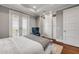 This bedroom features a balcony, recessed lighting, hardwood floors and an accent chair at 6771 Turtlemound Rd, New Smyrna Beach, FL 32169
