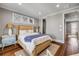 Bedroom features a woven-style bed frame, three cottage windows, and hardwood floors at 6771 Turtlemound Rd, New Smyrna Beach, FL 32169