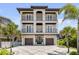Elegant three-story home with multiple balconies and a modern two car garage at 6771 Turtlemound Rd, New Smyrna Beach, FL 32169