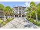 Attractive three-story home with multiple balconies, complemented by a patterned driveway and lush landscaping at 6771 Turtlemound Rd, New Smyrna Beach, FL 32169