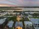 Exterior dusk shot of gorgeous beach home with beautiful views of the Halifax River at 6771 Turtlemound Rd, New Smyrna Beach, FL 32169