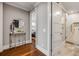 Hallway showcasing hardwood floors, stylish decor, and doorway leading to bedroom and bath at 6771 Turtlemound Rd, New Smyrna Beach, FL 32169