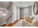 Hallway featuring hardwood floors, seating area and staircase leading to another floor at 6771 Turtlemound Rd, New Smyrna Beach, FL 32169