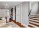 Hallway featuring a kitchenette, stairs, and a view into a bright living space at 6771 Turtlemound Rd, New Smyrna Beach, FL 32169