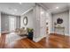 Elegant hallway with hardwood floors, seating area and sophisticated decorative touches at 6771 Turtlemound Rd, New Smyrna Beach, FL 32169
