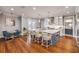 Modern kitchen featuring an island with bar seating, a dining table, and stainless steel appliances at 6771 Turtlemound Rd, New Smyrna Beach, FL 32169