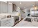 Modern kitchen with stainless steel appliances, white cabinetry, and stone countertops at 6771 Turtlemound Rd, New Smyrna Beach, FL 32169