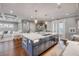Spacious kitchen with large island, marble countertop, stainless steel appliances, and hardwood flooring for luxurious style at 6771 Turtlemound Rd, New Smyrna Beach, FL 32169