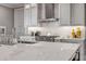 Modern kitchen with a large island, stainless steel appliances, and stylish white cabinetry at 6771 Turtlemound Rd, New Smyrna Beach, FL 32169