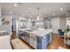 Gourmet kitchen features a large island with stainless steel appliances, custom cabinets, and elegant lighting fixtures at 6771 Turtlemound Rd, New Smyrna Beach, FL 32169