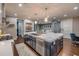 Beautiful open-concept kitchen features a large center island with marble countertop and stainless steel appliances at 6771 Turtlemound Rd, New Smyrna Beach, FL 32169