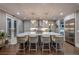 Bright kitchen features a large island with bar seating, pendant lighting, and stainless steel appliances at 6771 Turtlemound Rd, New Smyrna Beach, FL 32169