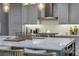 Bright kitchen showcasing a marble island, modern appliances, and pendant lighting at 6771 Turtlemound Rd, New Smyrna Beach, FL 32169