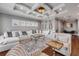 Bright living room with coffered ceiling, hardwood floors, fireplace, and comfortable seating at 6771 Turtlemound Rd, New Smyrna Beach, FL 32169
