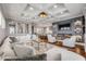 Open-concept living room features hardwood floors, a fireplace, TV, and a seamless flow to the kitchen at 6771 Turtlemound Rd, New Smyrna Beach, FL 32169