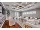 Stunning living room showcases coffered ceiling, hardwood floors and bright natural light at 6771 Turtlemound Rd, New Smyrna Beach, FL 32169