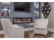 Cozy living room featuring a modern fireplace, hardwood floors, and comfortable seating at 6771 Turtlemound Rd, New Smyrna Beach, FL 32169