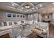 Bright living room with coffered ceiling, hardwood floors, fireplace, and comfortable seating at 6771 Turtlemound Rd, New Smyrna Beach, FL 32169