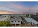 Beautiful ocean view between neighboring houses with sunset sky in the background at 6771 Turtlemound Rd, New Smyrna Beach, FL 32169