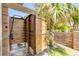 Enjoy this private outdoor shower, framed by a lush palm tree and brick accents, for a refreshing experience at 6771 Turtlemound Rd, New Smyrna Beach, FL 32169