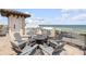 Enjoy ocean views from this rooftop deck featuring an elevator and comfortable seating around a fire pit at 6771 Turtlemound Rd, New Smyrna Beach, FL 32169
