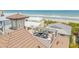 Aerial view of the rooftop deck with seating and beautiful beachside views at 6771 Turtlemound Rd, New Smyrna Beach, FL 32169