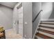 Stairway featuring wood treads, a handrail, and a view of two paneled doors with sleek hardware at 6771 Turtlemound Rd, New Smyrna Beach, FL 32169