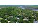 Aerial view of a landscaped property including a large home surrounded by large trees at 682 Ferncliff Dr, Port Orange, FL 32127