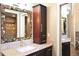 Elegant bathroom with a stone-framed mirror, granite countertop, and dark wood cabinetry at 682 Ferncliff Dr, Port Orange, FL 32127