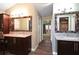 Spacious bathroom with double vanities, granite countertops, and wood-look tile flooring at 682 Ferncliff Dr, Port Orange, FL 32127