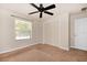 Bedroom with carpet flooring, standard closet and a window looking onto the outside at 682 Ferncliff Dr, Port Orange, FL 32127