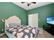 Green bedroom featuring a bed with floral pattern and a television on a stand at 682 Ferncliff Dr, Port Orange, FL 32127