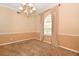 Traditional dining room with neutral carpet, chandelier, and large window at 682 Ferncliff Dr, Port Orange, FL 32127