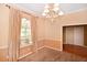 Dining room featuring a chandelier, carpet, and large window at 682 Ferncliff Dr, Port Orange, FL 32127
