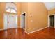 Inviting entryway with soaring ceilings, hardwood floors, and a glass front door at 682 Ferncliff Dr, Port Orange, FL 32127